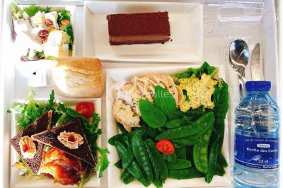 Logo d'un traiteur avec silhouette de chef et couverts, accompagné de photos de bouchées et plats variés colorés.