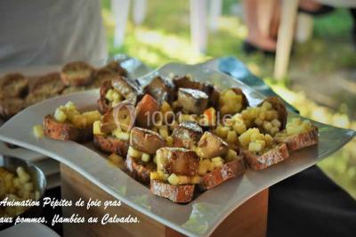Plateau de bouchées variées comprenant mini-sandwichs, brochettes de crevettes, œufs de caille et desserts colorés.