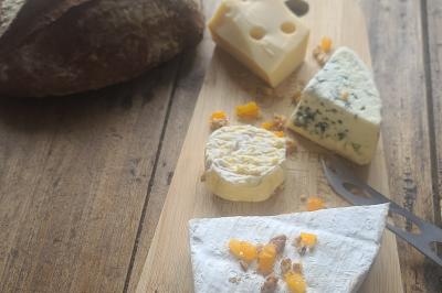 Plat composé d'une cuisse de volaille nappée de sauce, pommes de terre rôties et roulé de légumes en forme de fleur.