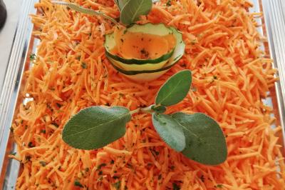 Table avec une pièce montée, des bouteilles de champagne, une pyramide de flûtes et une pile d'assiettes blanches.