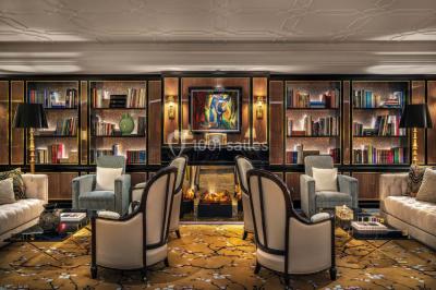 Salle de soins avec table de massage, produits de beauté, serviettes pliées, plantes et éclairage tamisé.