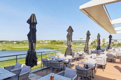 Salle intérieure avec simulateurs de golf, zone d'entraînement au putting et équipements sportifs modernes.