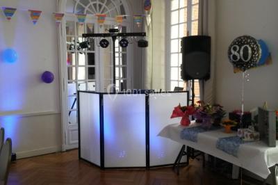 Groupe de personnes dansant sous des lumières colorées dans une salle avec un plafond industriel.