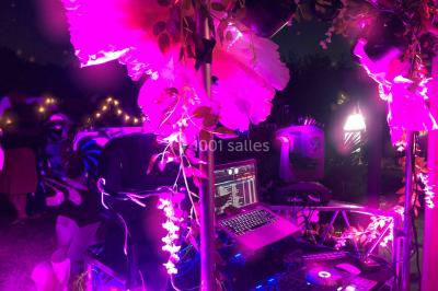 Deux femmes dansent et discutent dans une ambiance festive avec des lumières colorées.