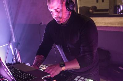 Homme souriant sur un char décoré, entouré de confettis colorés lors d'une parade festive.
