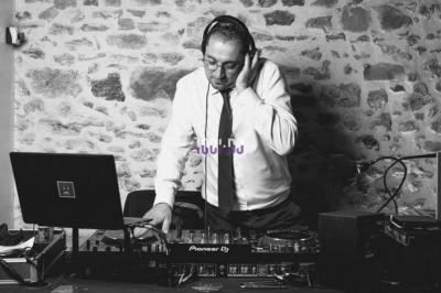 Une femme en robe blanche joue de la harpe dans une salle décorée avec des plantes et des lumières.