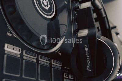 Miniature DJ Torcieu (Ain) - Monstro Event #3 Un DJ mixant de la musique sur une table de mixage éclairée par des lumières colorées dans une ambiance nocturne.