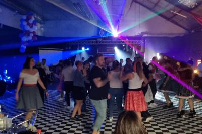 Homme portant un casque audio, vu de profil, concentré dans un environnement sombre en noir et blanc.