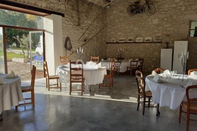 Salle de bain avec douche à l'italienne, lavabo double vasque, miroir éclairé et toilettes sur carrelage en terre cuite.