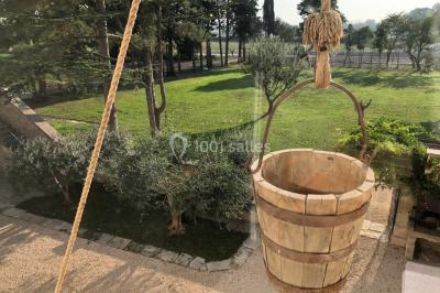 Salle de bain avec douche à l'italienne, lavabo double vasque, miroir éclairé et toilettes sur carrelage en terre cuite.