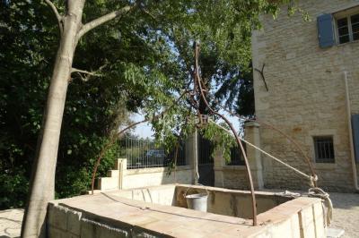 Salle de bain avec douche à l'italienne, lavabo double vasque, miroir éclairé et toilettes sur carrelage en terre cuite.