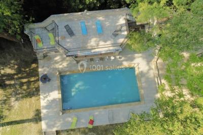 Salle de bain avec douche à l'italienne, lavabo double vasque, miroir éclairé et toilettes sur carrelage en terre cuite.