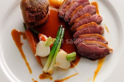 Gâteau de mariage décoré avec des choux, des fleurs en sucre et des cierges magiques allumés.