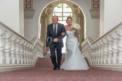 Un couple danse sous des lumières colorées dans une ambiance tamisée.