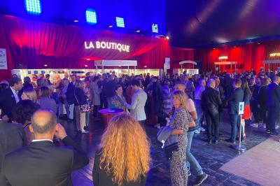 File d'attente devant un chapiteau de cirque blanc avec un guichet de billetterie sur la gauche.