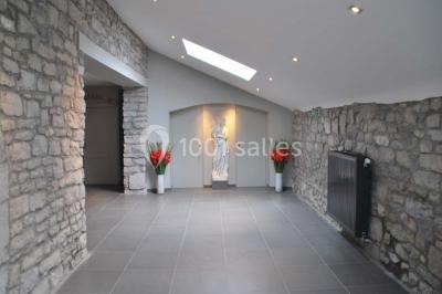 Voûtes en briques rouges soutenues par des colonnes en pierre dans une pièce au sol carrelé.