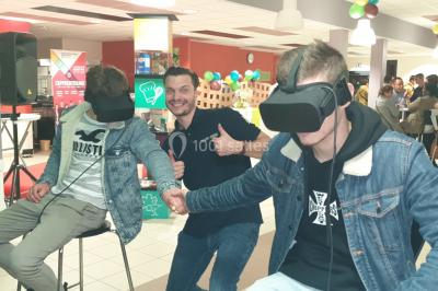 Flammes vives s'élevant d'un feu de bois sous une grille métallique, entourées de pierres sombres.