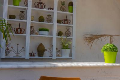 Salon avec fauteuils en cuir, table basse en bois, plante verte, bibliothèque et tableau sur un mur lambrissé.