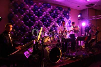 Salle de restaurant élégante avec tables dressées, nappes colorées, chaises modernes et décoration végétale.