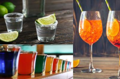 Verres de cocktails variés, dont des shots avec citrons verts et des spritz orange, posés sur des tables en bois.