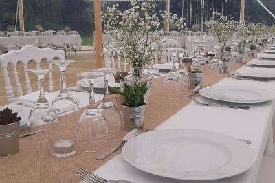 Miniature Location salle Milizac (Finistère) - Domaine de Keranflec'h #4 Structure en bois avec un toit tendu, installée dans un espace extérieur verdoyant et ensoleillé.