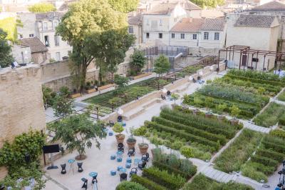 Pont en pierre à arches traversant une rivière, avec des visiteurs et un ciel dégagé en arrière-plan.