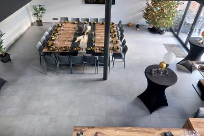 Structure gonflable colorée en forme d'arche, installée sur une cour pavée devant des maisons en briques.