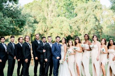 Allée verdoyante ombragée par des arbres, avec une pelouse ensoleillée au centre.