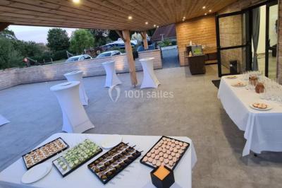 Étang entouré d'arbres illuminés la nuit, avec leurs reflets visibles sur l'eau calme.