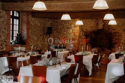 Un couple de dos observe des lanternes volantes dans un cadre nocturne entouré de convives.