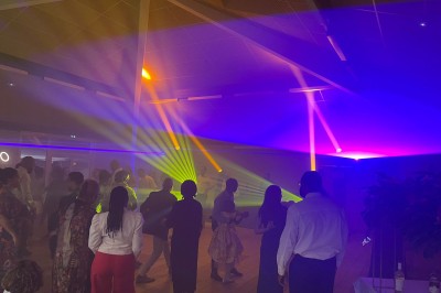 Installation de matériel de sonorisation et d'éclairage avec projecteurs et enceintes dans une salle de réception.