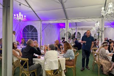 Chambre avec un lit double, éclairage doux et une grande bibliothèque en bois remplie de livres en arrière-plan.