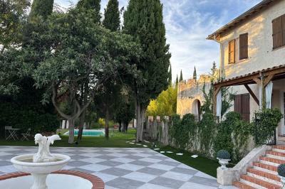 Chambre avec un lit double, éclairage doux et une grande bibliothèque en bois remplie de livres en arrière-plan.