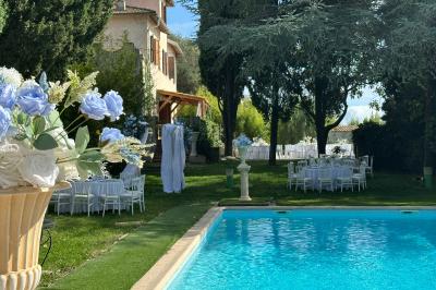 Chambre avec un lit double, éclairage doux et une grande bibliothèque en bois remplie de livres en arrière-plan.