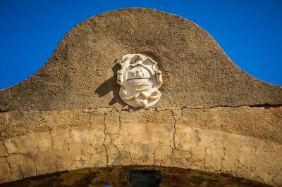 Fauteuils en rotin avec coussins blancs disposés dans un cadre naturel entouré d'arbres et de végétation.