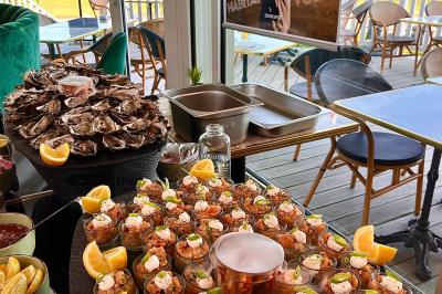 Assiette avec un bloc de foie gras, tranche de pain brioché, poire pochée et décorations de crème et noisettes.