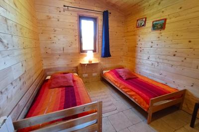 Tente tipi blanche installée sur une pelouse avec une table de pique-nique à proximité, entourée de verdure.