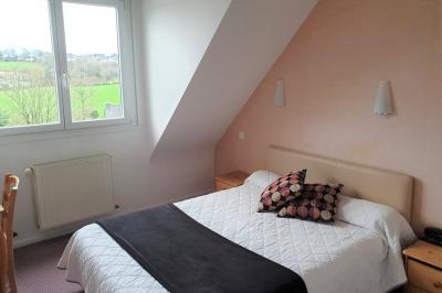 Miniature Location salle Ergué-Gabéric (Finistère) - L’Orée du Bois #9 Vue sur un jardin avec des arbres, une maison blanche et un paysage de campagne sous un ciel nuageux.