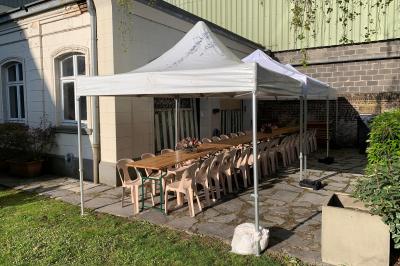 Un coussin jaune sur un lit blanc avec une pancarte suspendue indiquant un message écologique.