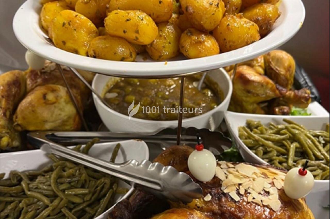 Assortiment de plats comprenant poulets rôtis, haricots verts, pommes de terre épicées et sauce servie en bol.