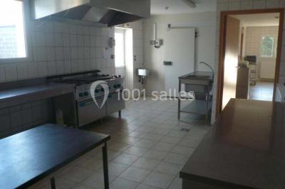 Vue aérienne d'un domaine rural avec bâtiments en pierre, cour centrale, champs, étang et arbres environnants.