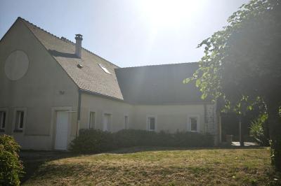 Cuisine professionnelle vide avec plans de travail en inox, murs carrelés blancs, fenêtres et extincteur visible.