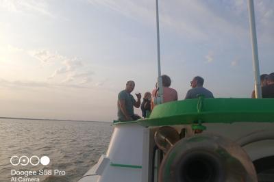 Château illuminé au sommet d'une colline, reflété dans l'eau calme au crépuscule.