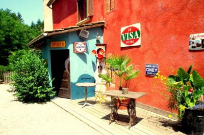 Lit double avec drap blanc, encadré par deux tables de chevet et lampes, dans une chambre au mur bleu et sol en bois.