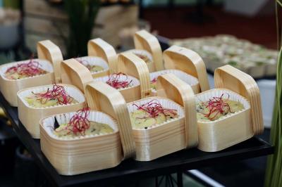 Miniature Traiteur Aix-en-Provence (Bouches-du-Rhône) - Carré Gourmand #4 Une mariée en robe blanche tient un bouquet dans une salle décorée pour un mariage, avec un homme en costume bleu derrière…