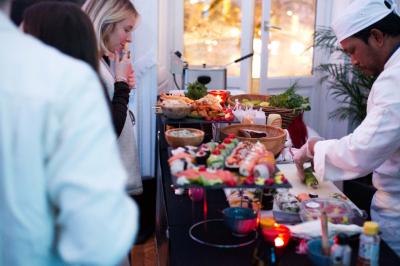 Groupe de personnes en vêtements d'hiver rassemblées dans une pièce éclairée par une lumière bleutée.