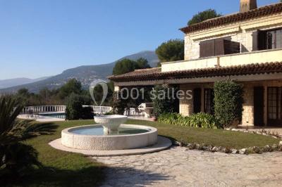 Table élégamment dressée avec chandeliers, verres et décorations sous un plafond illuminé de guirlandes lumineuses.