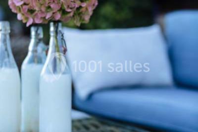 Des personnes discutent en petits groupes lors d'un événement dans une salle élégante avec des vitraux et une fresque murale.