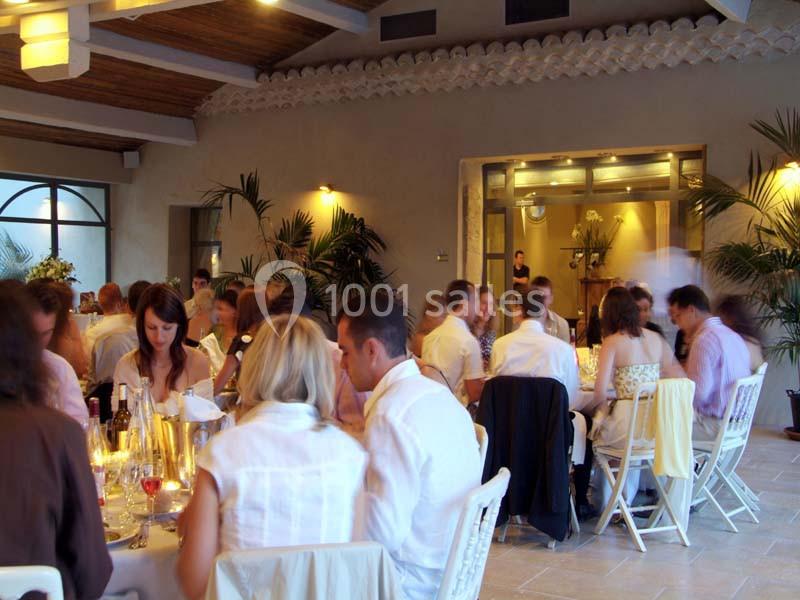 Location salle Sorgues (Vaucluse) - Château La Tour Vaucros #5 Des convives assis autour de tables dans une salle lumineuse avec des plantes et un décor chaleureux.