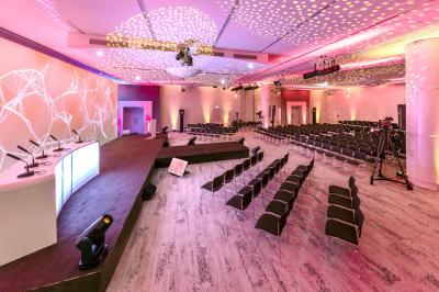 Dessert au chocolat garni de mangue, copeaux de noix de coco et pistaches, présenté sur une assiette verte.